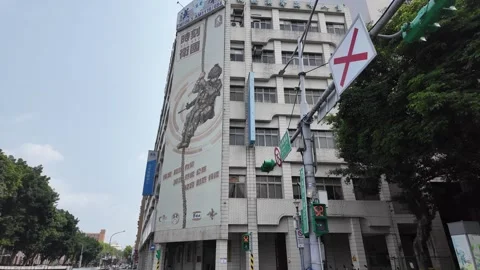 A large mural of a warrior decorates a multi-story building facade. Stock Footage 333660449