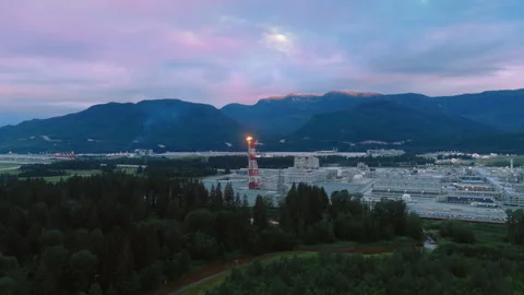 A large natural gas processing facility set against the mountains in Kitimat, BC Stock Footage 317953037