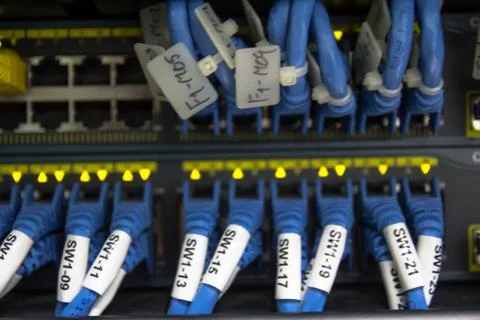 Large network hub and connected internet cables Stock Photos