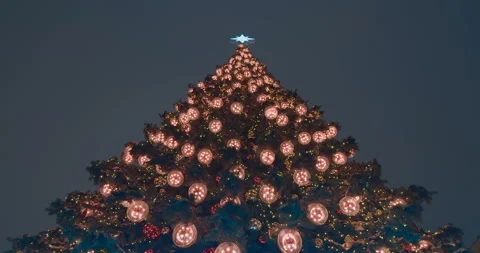 Large New Year tree glowing with colorful lights on the street Stock Footage 119546646