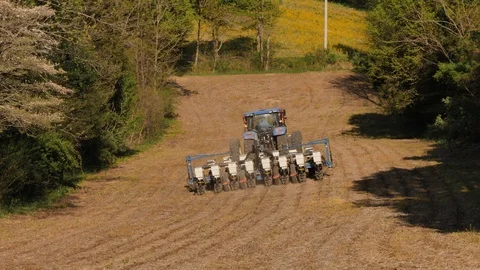 Large No Till Corn Planter between a Row of Trees in Kentucky Stock Footage 96750974
