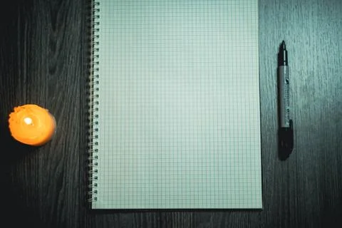 Large notebook and black marker in candlelight Foto stock