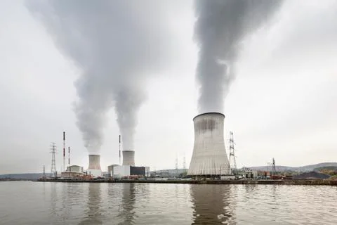 A large nuclear power station by a river on a gray day Stock Photos