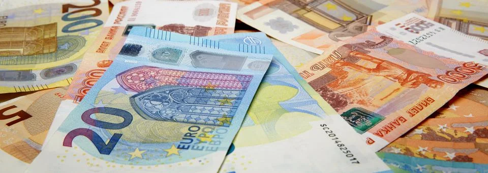 Large number of banknotes of different value of the euro and Russian rubles Stock Photos