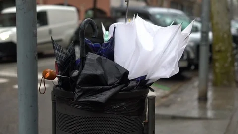 A large number of broken umbrellas in the trash on the street during a storm 스톡 동영상 123610868