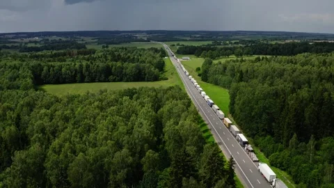 Large number of cargo trucks stuck in a long queue on a highway. Stock Footage 290391747