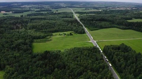 Large number of cargo trucks stuck in a long queue on a highway. Stock Footage 290404048
