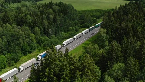 Large number of cargo trucks stuck in a long queue on a highway. Stock Footage 290404083