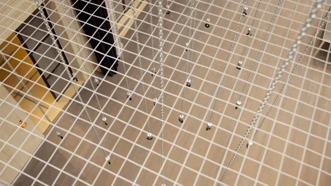 Large Number of Chained Hooks are Raised by Motorized Hoists Stock Footage 262111597