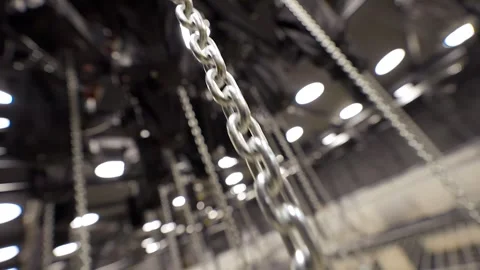 Large Number of Chains are Lowered by Motorized Hoists Stock Footage 262111677