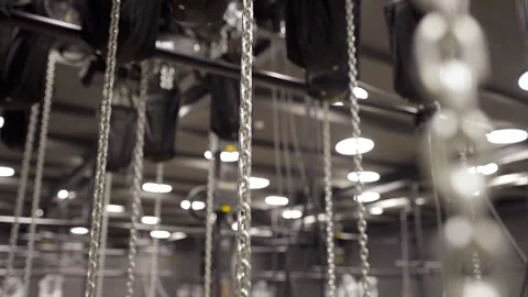 Large Number of Chains are Raised by Motorized Hoists Stock Footage 262111652