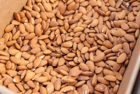 A large number of closely packed almonds with a light brown hue and texture.. Stock Photos