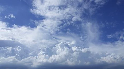 A large number of clouds moved slowly in the bright blue sky. Stock Photos