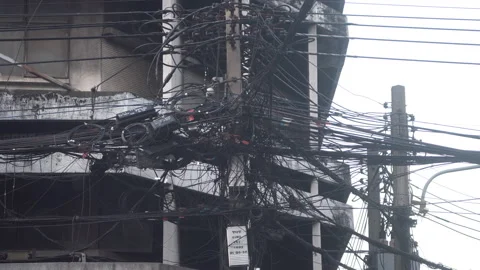 Large number of electrical wires above street in city . Video stock 181788990