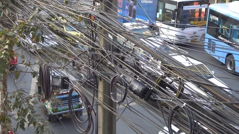 Large number of electrical wires on electric post above street Stock Footage 104008522