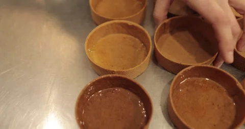 A large number of mini-tarts are laid out in even rows Stock Footage 253408495