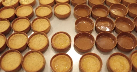 A large number of mini-tarts are laid out in even rows Stock Footage 253408937