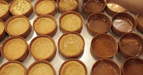 A large number of mini-tarts are laid out in even rows Stock Footage 253410142