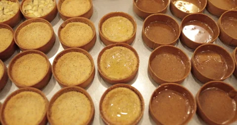 A large number of mini-tarts are laid out in even rows Stock Footage 253410147