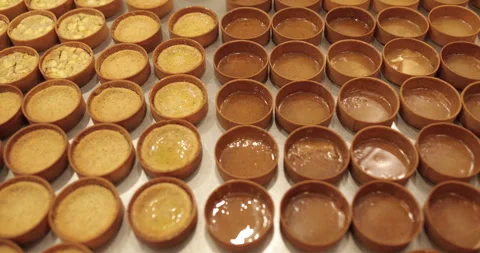 A large number of mini-tarts are laid out in even rows Stock Footage 253410266