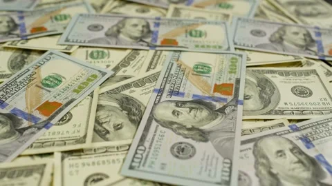 A large number of old and new dollars are scattered on the table. Stock Footage 265253196