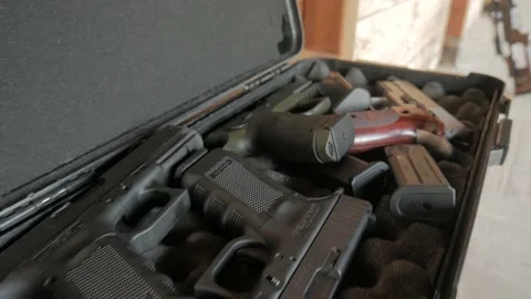 A large number of pistols in a special case for weapons Stock Footage 194795562