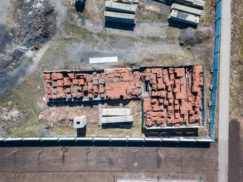 A large number of red bricks stacked on pallets near the construction site in Stockfoto's
