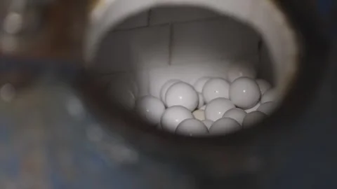 A large number of white balls are in a container Stock Footage 302456830