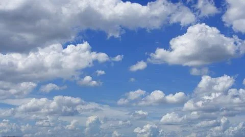 A large number of white clouds of various sizes in the sky. Stock Photos