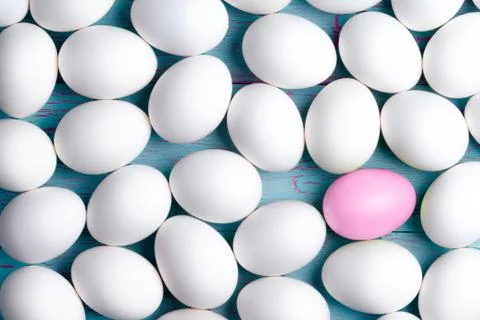 Large number of white Easter eggs and one pink one Stock Photos