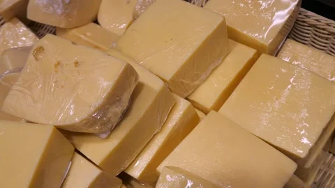 A large number of yellow cheeses in a package, lying in a basket. Stock Footage 301245283
