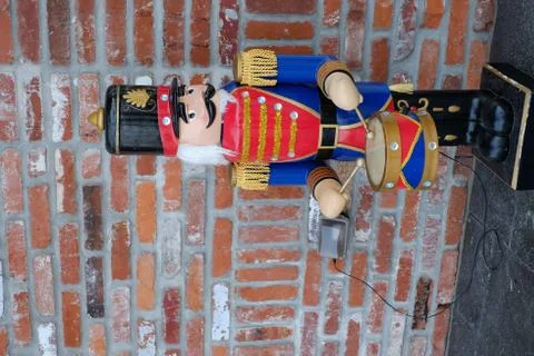 Large nutcracker in front of brick building 스톡 사진
