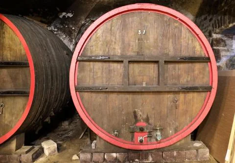 Large oak wine fermentation vats in a historic underground cellar in Beaujo.. 스톡 사진
