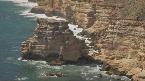 Large Ocean Rock Next to Cliff Stock Footage 316005919
