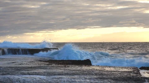Large ocean wave crashing into the rock shore Stock Footage 112974058