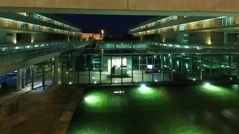 Large office building, two workers at night in office suspended over water Vídeo Stock 278750958