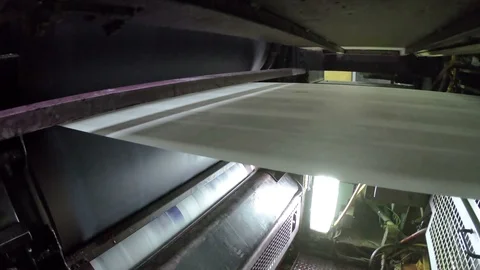 A large offset printing press running a long roll off paper over its rollers  Stock Footage 94673177