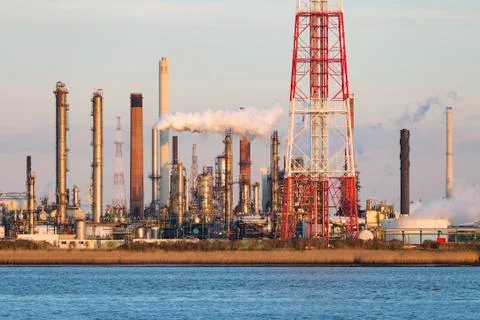 A large oil refinery with flare stack in the port of Antwerp, Belgium with lo Stock Photos