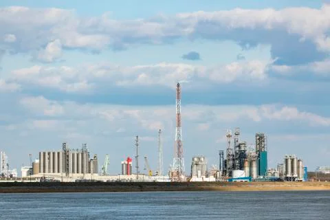 A large oil refinery with flare stack in the port of Antwerp, Belgium with lo Stock Photos
