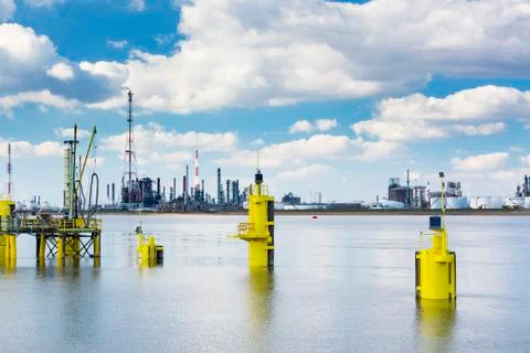 A large oil refinery with smoke stacks in the port of Antwerp, Belgium with l Stock Photos
