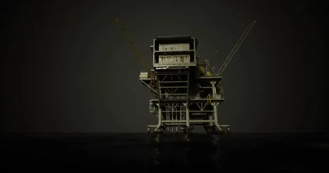 Large oil rig platform illuminated at night over calm waters Stock Footage 308672376