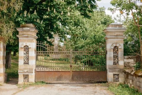 Large old iron gate with columns. castle entrance Stock Photos