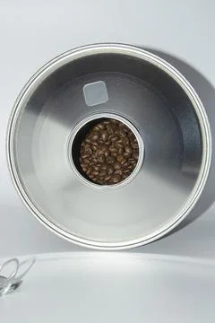 Large open jar of coffee beans on a white background. Stock Photos