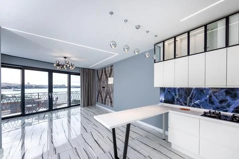A large open kitchen with a blue and white tile backsplash Stock Photos