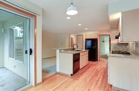 Large open kitchen with granite counter tops, maple cabinets with built in bl Stock Photos