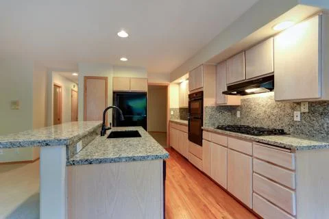 Large open kitchen with granite counter tops, maple cabinets with built in bl Stock Photos