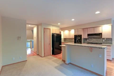 Large open kitchen with granite counter tops, maple cabinets with built in bl Stock Photos