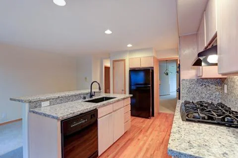 Large open kitchen with granite counter tops, maple cabinets with built in bl Stock Photos