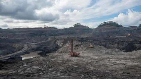 Large open-pit coal mine operation with heavy machinery and drilling equipment Stock Photos