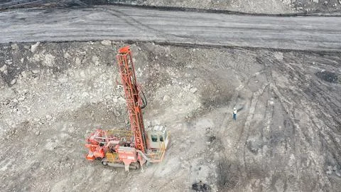 Large open-pit coal mine operation with heavy machinery and drilling equipment Stock Photos